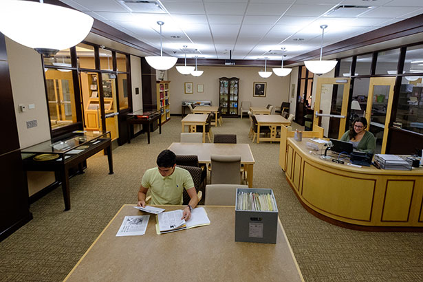photo of the Havighurst Special Collections reading room, with a student seated at a work table examining archival documents