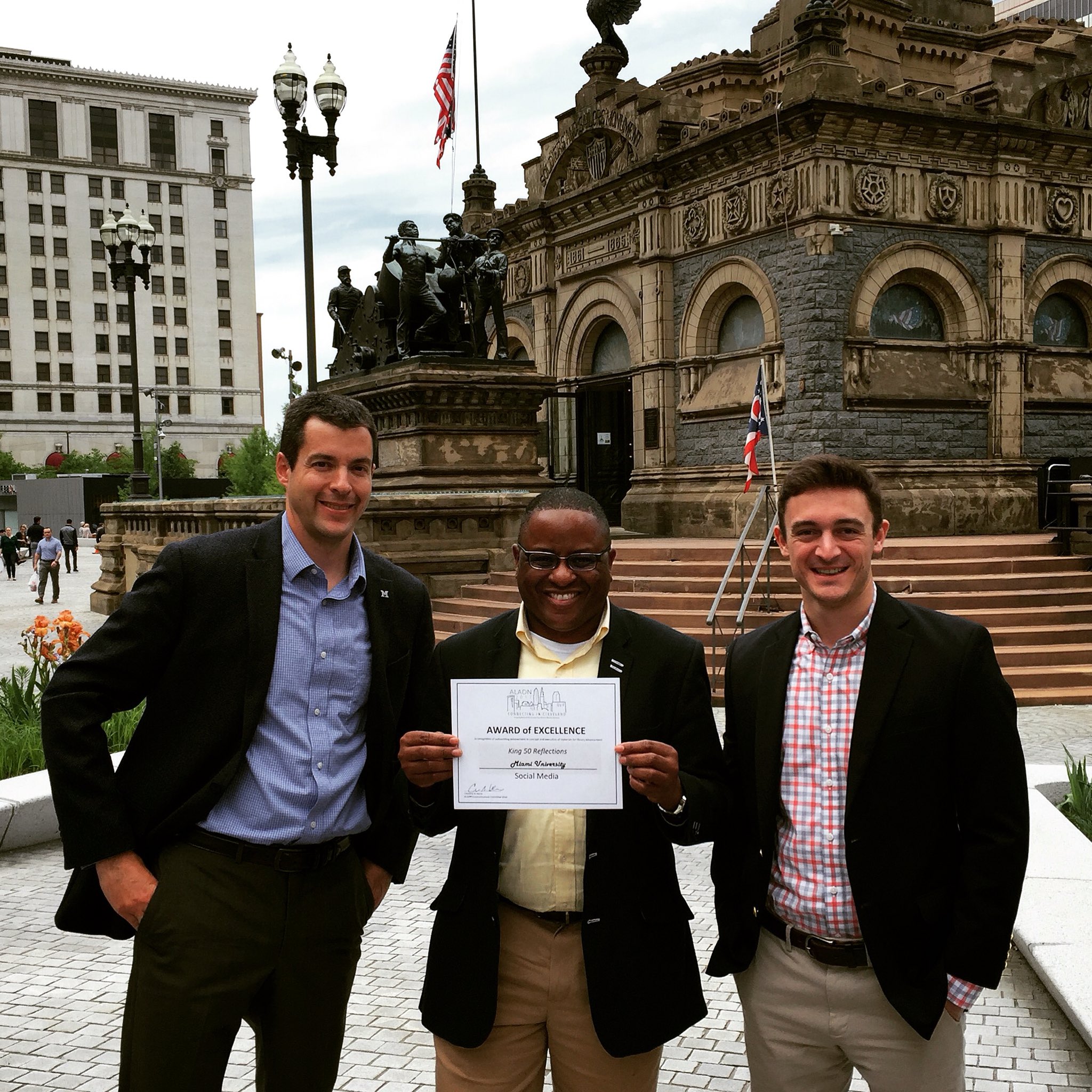 Vince Frieden, Jerome Conley, and David Mulford holding an Award of Excellence recognizing the 'King 50 Reflections'